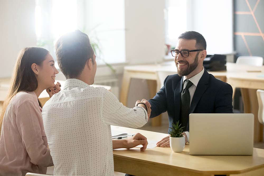 Smiling Lawyer, Realtor Or Financial Advisor Handshaking Young C